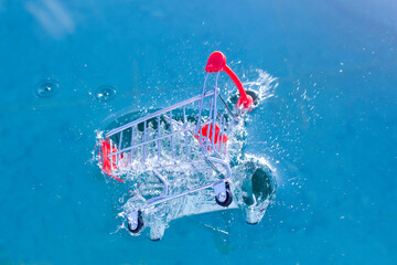 a shopping cart falls into the water and sinks. concept