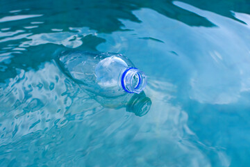plastic bottle floats on the surface of the water