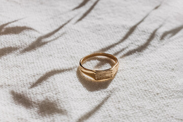 Golden ring in natural light close-up. Minimalist jewelry