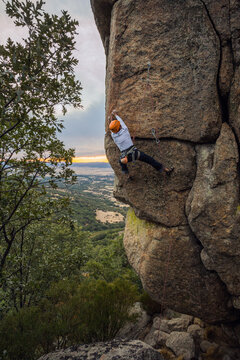 Climber in equipment climbing mountain helping with hand and leg