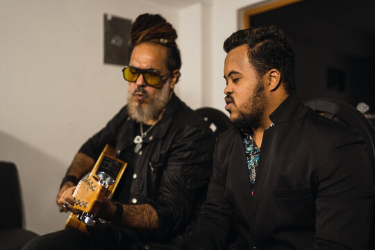Father and son playing guitar and singing