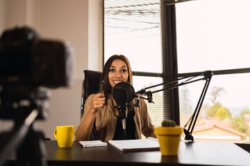 Woman on radio station writing on a notepad