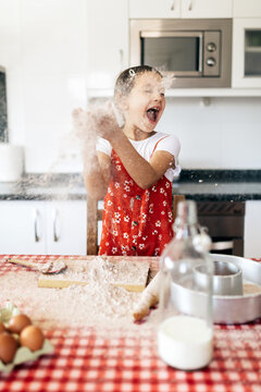 Girl Throwing Flour In Kitchen