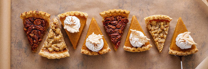 Variety of fall pie slices on parchment paper