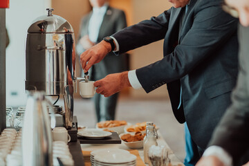 Close-up photo of businessmen serving themselves in a modern hotel during a dinner party. Selective focus 