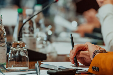 Close-up of male hands with pen over document. Selective focus 