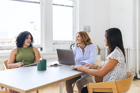 Multiracial business colleagues discussing strategy in office stdio