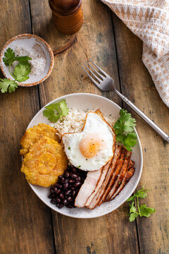 Caribbean or latin american breakfast with rice, beans and pork