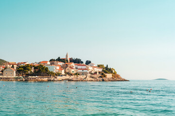 Fototapeta na wymiar Cityscape of Primosten peninsula and clear blue sky and sea. Croatia, Primosten