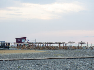 Bar by the sea. Resort place. Umbrellas and sunbeds on the beach. Beach at sunset. Beach business.