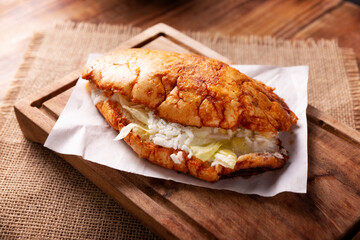 Pambazo. Sandwich marinated in sauce and roasted on a comal traditionally stuffed with potatoes and chorizo, a classic of Mexican street food.