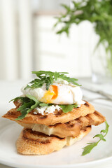 Delicious sandwich with arugula and egg on white plate