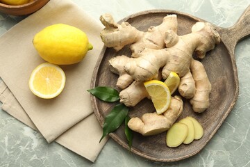 Fresh lemons and ginger on grey marble table, flat lay
