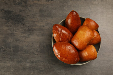 Delicious baked patties on grey table, top view. Space for text