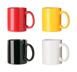 Set with different ceramic mugs on white background