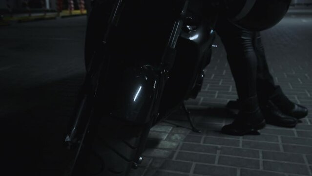 Young couple kissing on a motorcycle in underground parking garage