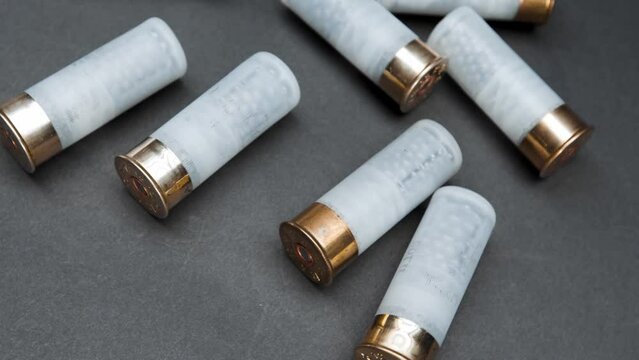Close-up: shotgun cartridges on a table against a dark background