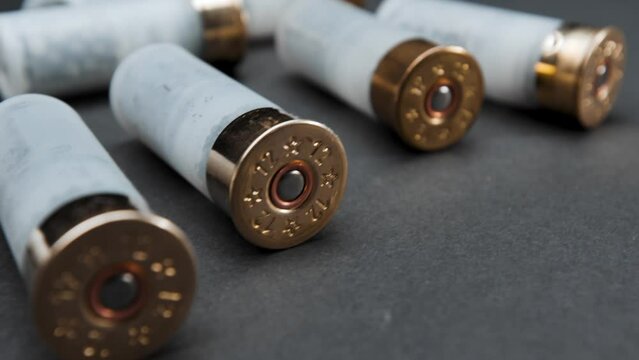 Close-up: shotgun cartridges on a table against a dark background