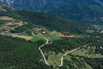 View from above of a winding road in the middle of nature