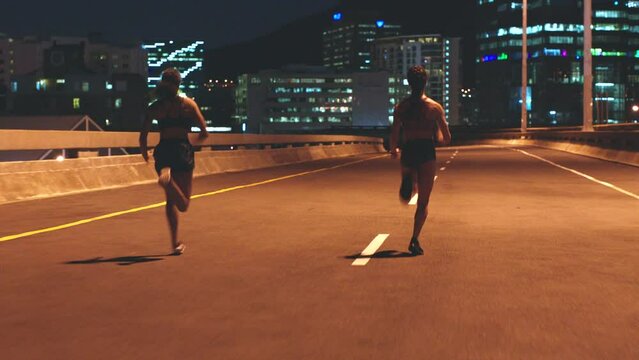 Women training in city street at night and athlete exercise running. Sports fitness runners, health motivation race workout road energy together cardio outdoor dark sprint practice for olympics