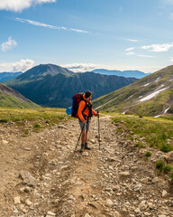 Fototapeta premium Man hiking in northern Canada, Yukon Territory during summertime. 
