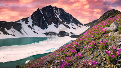 Fototapeta na wymiar Incredible sunset background views from Yukon, Canada with pink pastel sunset and glacial lake. 