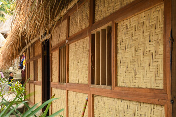 Traditional design of the exterior of SASAK houses in Sade Village, Lombok, Indonesia. Frame and roof are made of wood, bamboo and straw leaves of coconut trees.