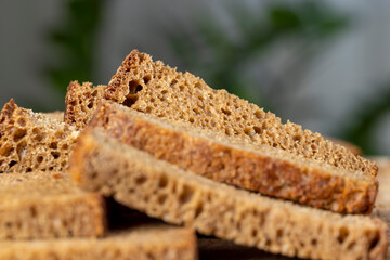 Sliced piece of black rye bread on a board