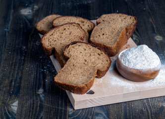 sliced rye bread on a wooden table, close up