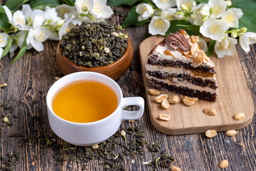 Fototapeta na wymiar Brewed green tea with jasmine on the table