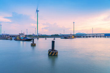 Fototapeta premium Yangtze River port wharf and wind turbine and sunset scenery in Jiangyin City, China