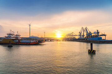 Fototapeta na wymiar Yangtze River port wharf and wind turbine and sunset scenery in Jiangyin City, China
