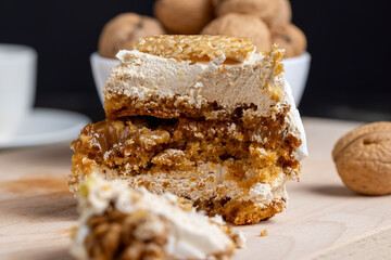 a piece of cake with buttercream and walnuts