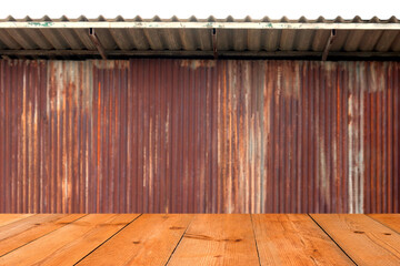 perspective wooden board over blur old rusty galvanized sheet