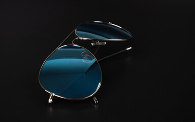 blue polarized sun glasses closeup on dark background