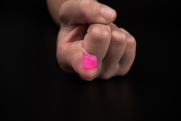 pink lsd stamp mark on fingertip, recreational drugs lysergic acid intake