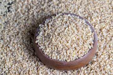 Fresh uncooked bulgur porridge on the table