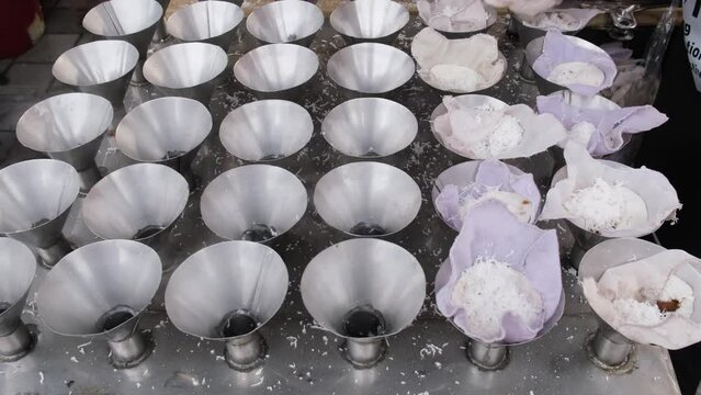 Traditional putu piring dessert preparation. Delicious street food