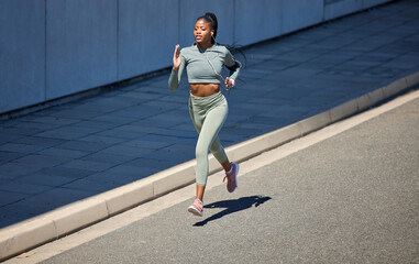 City street, fitness and running woman with earphones listening to music or motivation audio for health workout with outdoor mockup. Black woman jogging or exercise training with a wellness podcast