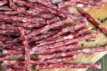 thin dried meat sausages with spices , close up