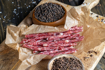 thin dried meat sausages with spices , close up