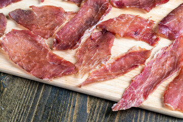 Obraz premium thin pieces of dried meat with spices