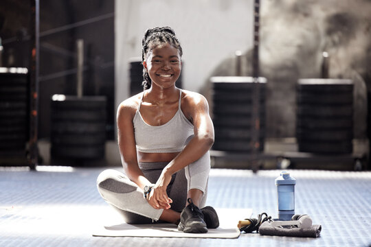 Black woman, fitness break and exercise workout in sports gym, training club and wellness. Portrait of happy, motivation and strong african athlete with healthy lifestyle, goal vision and active rest