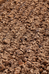 The plowed soil in the field