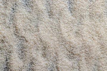 a pile of scattered white rice on the kitchen table