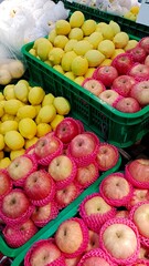 Fresh fruits in basket on farm market shelf.