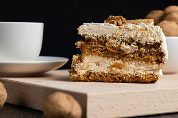 a piece of cake with buttercream and walnuts