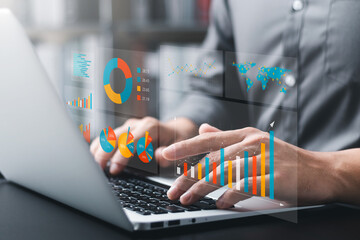 Businessman analyzing company's financial balance sheet working with digital augmented reality graphics. Businessman calculates financial data for long-term investment.