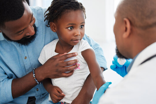 Father, child in consultation with pediatrician doctor for medical healthcare, insurance and trust. Black people, girl and men consulting appointment in hospital clinic for kid or toddler vaccination