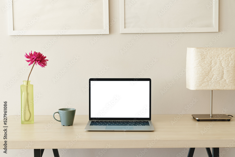 Poster laptop computer on desk showing white screen